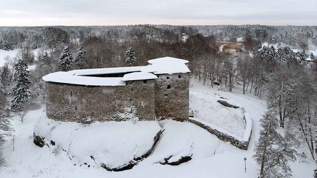 Aerial photograph taken in winter. A large old castle, partly with roof, partly without.