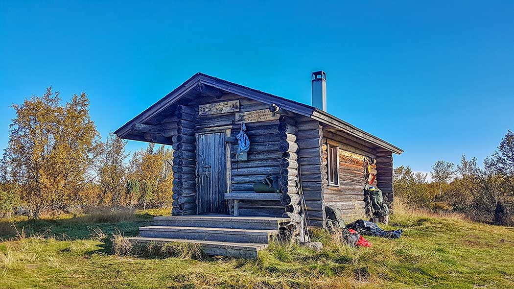 Naltijärvi open wilderness hut in late summer. The leaves in the mountain birches have started to turn yellow.